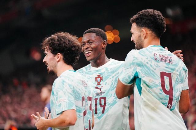 Portugal-s-midfielder-Vitinha-celebrates-scoring-a-against-Norway-with-teammates-Nuno-Mendes-and-Goncalo-Ramos (1).jpg